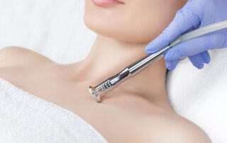 woman on medspa bed receiving Décolletage Treatments from professional